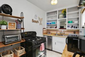 a kitchen with a stove and a sink at 210 Forty Fourth Street in Newport Beach