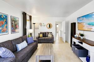 a living room with a couch and a tv at 210 Forty Fourth Street in Newport Beach