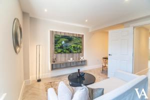 a living room with a white couch and a table at Velvet Apartments - 10 Park Square East in Leeds