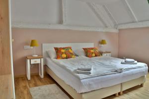 sypialnia z dużym białym łóżkiem z dwoma stołami w obiekcie Gościniec Nowa Wioska w Wałbrzychu