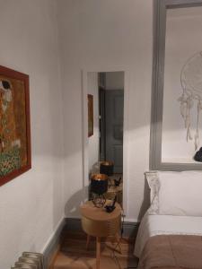a bedroom with a bed and a table and a tub at Casas Zé Pinto in Hospital