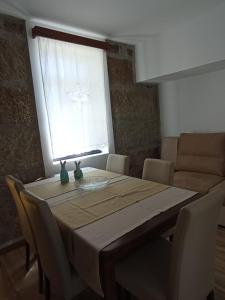 a dining room table with chairs and a window at Casas Zé Pinto in Hospital