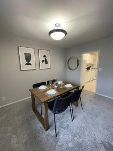 a dining room with a wooden table and chairs at Discover an exclusive Condo at Crystal City with gym in Arlington