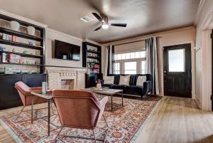 a living room with a couch and a fireplace at Boho Glam Bungalow mins away Western Ave Districts in Oklahoma City