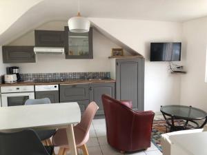 a kitchen with a table and chairs in a room at Appartement vue sur Mer in Plérin