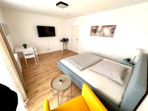 a small bedroom with a bed and a chair at Business Apartment Lörrach in Lörrach