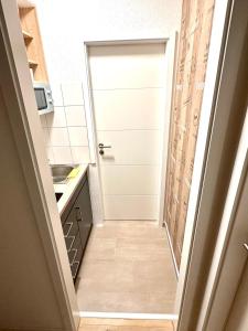 a hallway leading into a kitchen with a door at Business Apartment Lörrach in Lörrach