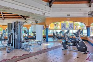 a gym with treadmills and cardio equipment in a building at Sandy Beach Princesa D101 Ocean Front Resort in Puerto Peñasco