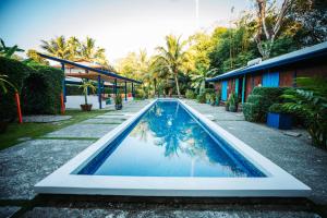 a swimming pool in the yard of a house at Blue Osa Beach Resort & Spa in Puerto Jiménez