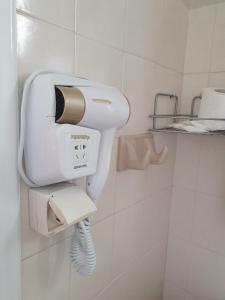 a hair dryer on a wall in a bathroom at Daglas Seaside Studios in Nydri