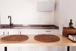 two wooden mats sitting on a counter in a kitchen at Serendipia: tu hogar en este blanco pueblo in Frigiliana