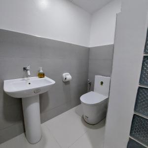 a bathroom with a sink and a toilet at Matteo's hus VILLA RENTAL in Zamboanguita