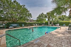 a swimming pool with people in the water at Walk to Beach Hilton Head Island Resort Gem in Hilton Head Island