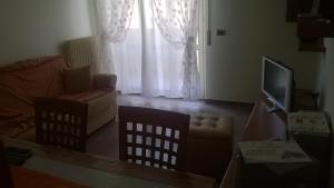 a living room with a couch and a television at Roseto degli Abruzzi Apartment in Roseto degli Abruzzi
