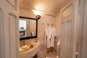 a bathroom with a sink and a large mirror at Riad Agathe & Spa in Marrakesh
