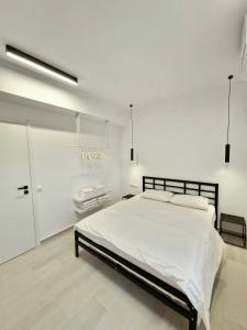 a white bedroom with a large bed in it at plefsea in Afitos