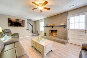 a living room with a couch and a fireplace at Memphis Vacation Rental - Walk to Graceland! in Memphis