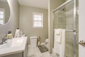 a bathroom with a shower and a sink and a toilet at Memphis Vacation Rental - Walk to Graceland! in Memphis +25 photos