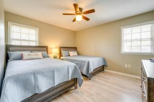 a bedroom with two beds and a ceiling fan at Memphis Vacation Rental - Walk to Graceland! in Memphis