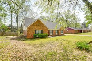 a home with a brick house with a yard at Memphis Vacation Rental - Walk to Graceland! in Memphis