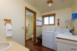 a bathroom with a washing machine and a sink at Pacific Lookout in Florence