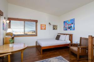 a bedroom with a bed and a table and a window at Pacific Lookout in Florence