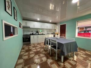 una cocina con mesa y sillas. en Casa de campo, en Curacautín