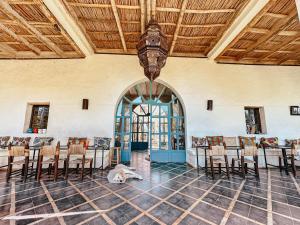 a dog laying on the floor in a room with chairs at LE BLED DE GRE in Marrakech