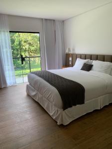 Ένα ή περισσότερα κρεβάτια σε δωμάτιο στο Pousada Menino de Ouro