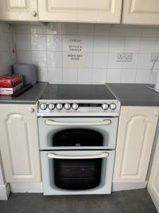 a kitchen with a white oven in a kitchen at The Eden Suite Private Room in Dublin