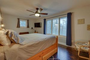 a bedroom with a bed and a ceiling fan at Lakefront Butler Home with Hot Tub, Fire Pit and Dock in Butler