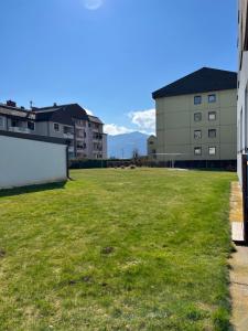 a large field of grass in the middle of buildings at Apartament Acasa in Spielberg