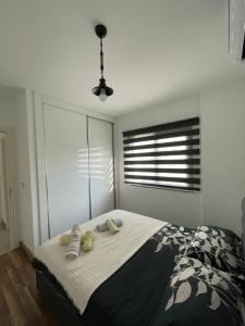 a bedroom with a bed with two pillows and a window at Girnenin kalbinde tatil in Kérynia +5 photos