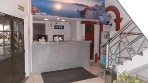 a lobby with a bar with a mural on the wall at Hotel Virreyes in San Fernando