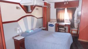 Postel nebo postele na pokoji v ubytování Hotel Virreyes