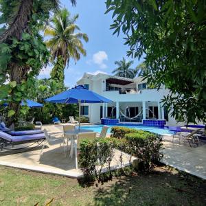 a villa with a pool and a table and chairs at Condominio El Peñon in Girardot
