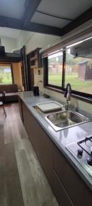 a kitchen with a sink and a counter top at Cabañas Alto Bosque in Pucón