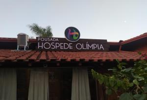 a sign on the top of a building at Pousada Hospede Olimpia in Olímpia