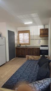 a kitchen with a large bed in the middle of a room at Finde y Vacaciones in San Rafael