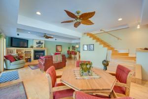a living room with a table and a couch at Bright Minong Vacation Rental on Little Sand Lake! in Minong