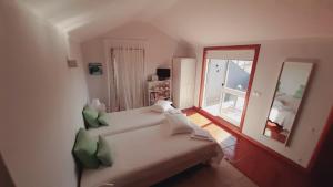 a living room with a couch and a mirror at SUN & SAND GUESTHOUSE in Esposende