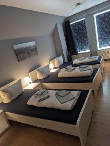 two beds in a room with two windows at Flensburg Zentrum 10 VH 2OG R in Flensburg