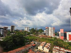 a city with tall buildings and a cloudy sky at San Luis, norte de Armenia in Armenia