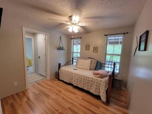 a bedroom with a bed and a ceiling fan at Gigi's Spacious Lakefront with Boat Ramp Access!! Newly Remodeled, Sleeps 8! in Canadian