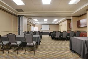 a conference room with tables and chairs and a whiteboard at Best Western Brantford Hotel and Conference Centre in Brantford