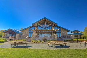 a building with picnic tables in front of it at Hot Tub and Resort Amenities Pocono Lake Retreat! in Pocono Lake