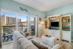a living room with a couch and a tv at Bethany Beach Inn -- 102 Bethany Beach Inn in Bethany Beach