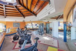 a gym with treadmills and exercise bikes in a room at Sandy Beach Princesa A103 Ocean Front Resort in Puerto Peñasco