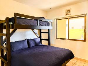 a bedroom with two bunk beds and a window at Sandy Beach Princesa A103 Ocean Front Resort in Puerto Peñasco +37 photos