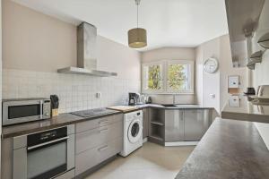 a kitchen with a sink and a dishwasher at "Joie de vivre" - Parisian Spacious & Charming flat in Asnières-sur-Seine
